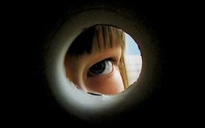 View of a child looking out a peephole, limiting what can be known